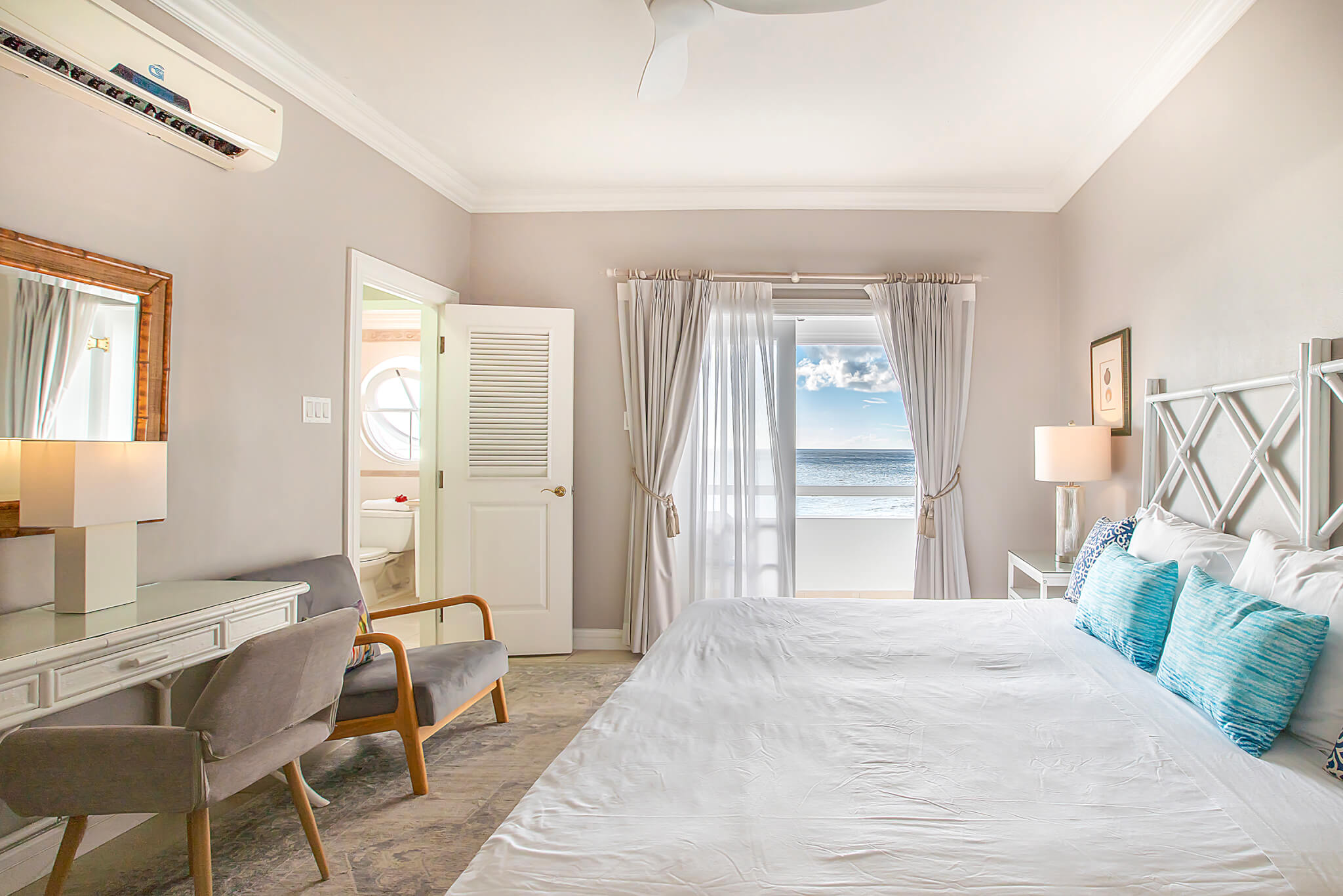 Bedroom with magnificent views of a Barbados beach out of the window and over the balcony